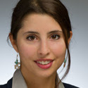 Headshot of Perin Gurel, a women wearing a collared shirt and jacket. She has brown hair and brown eyes and is looking directly into the camera.