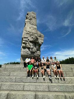 Erin Drumm, her classmates, and Professors Charles Powell and Emilia Justyna Powell at the Westerplatte monument in Gdańsk, Poland.
