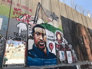 Photo of art that has been painted on one of the walls that separate Israel from Palestine.