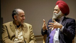 Dr. Waleed El-Ansary and Dr. Nirvikar Singh engage in animated conversation.
