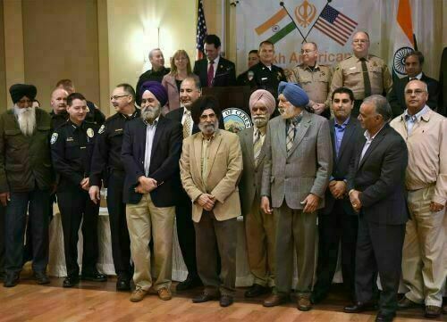 Professor Nirvikar Singh (fourth from left) was the invited speaker to a large audience of law enforcement officers (including the Sheriffs of four counties), attorneys, politicians, and Sikh community members in order to educate them on the history and presence of the Sikh community in the the US.