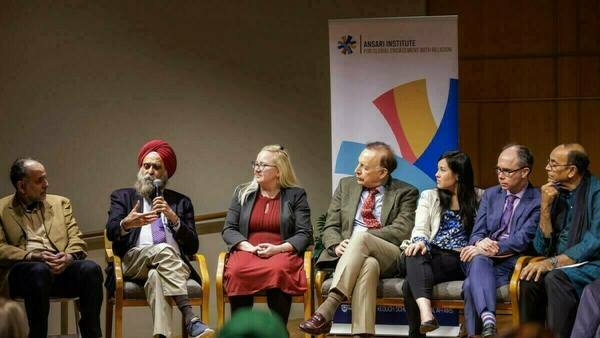 Multiple panelist comprising of 7 individuals - including Professor Nirvikar Singh (second from left) participate ion the final session of the Ansari Institute's annual Book Prize on World Religions.