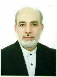 Headshot of Mohammad Mozaffari - an adult male. He is looking directly at the camera. He has a white beard and is wearing a white shirt with dark buttons and no collar. He has a suit jacket on.
